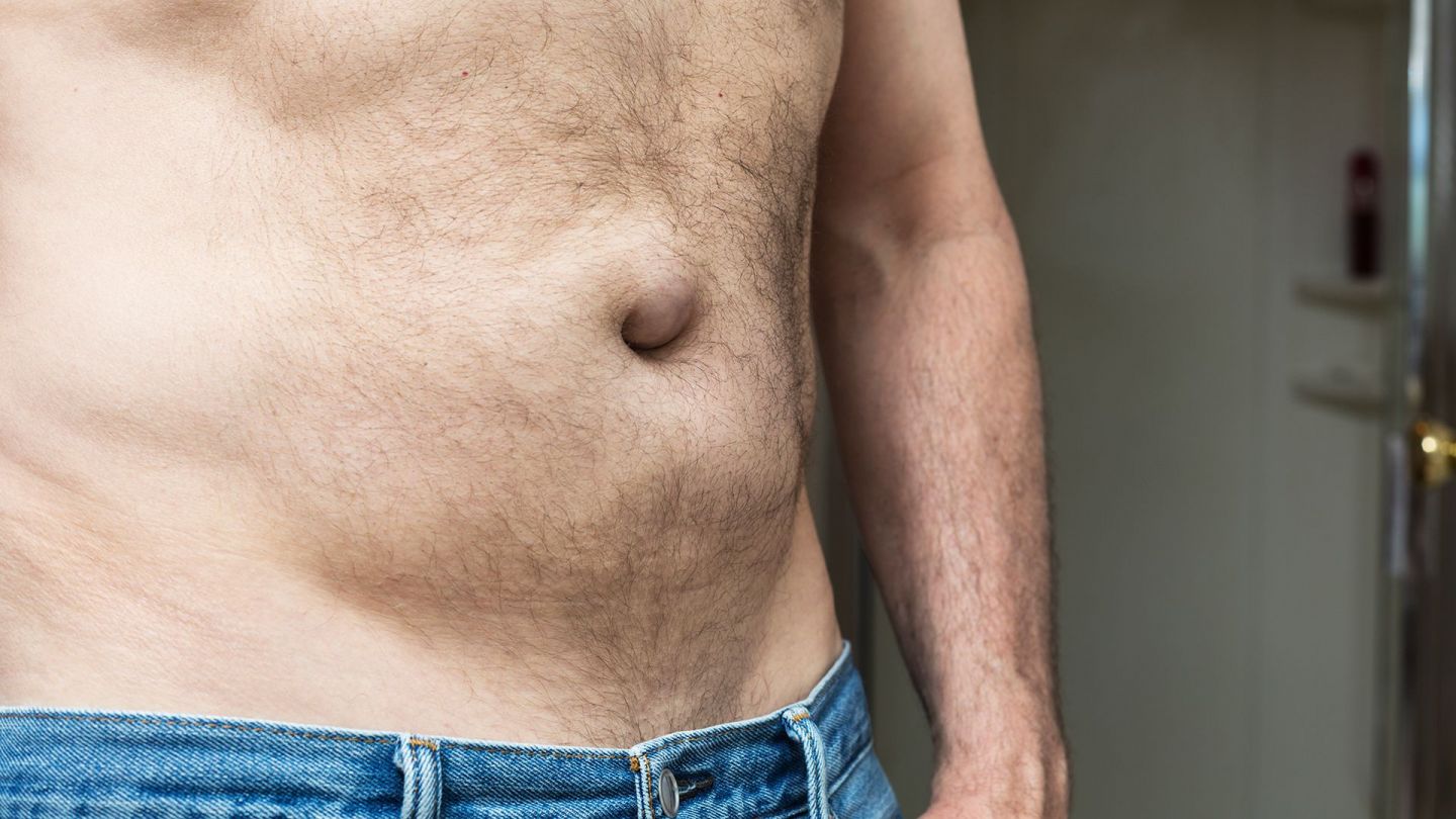 Hernia: man showing his bare chest and belly.