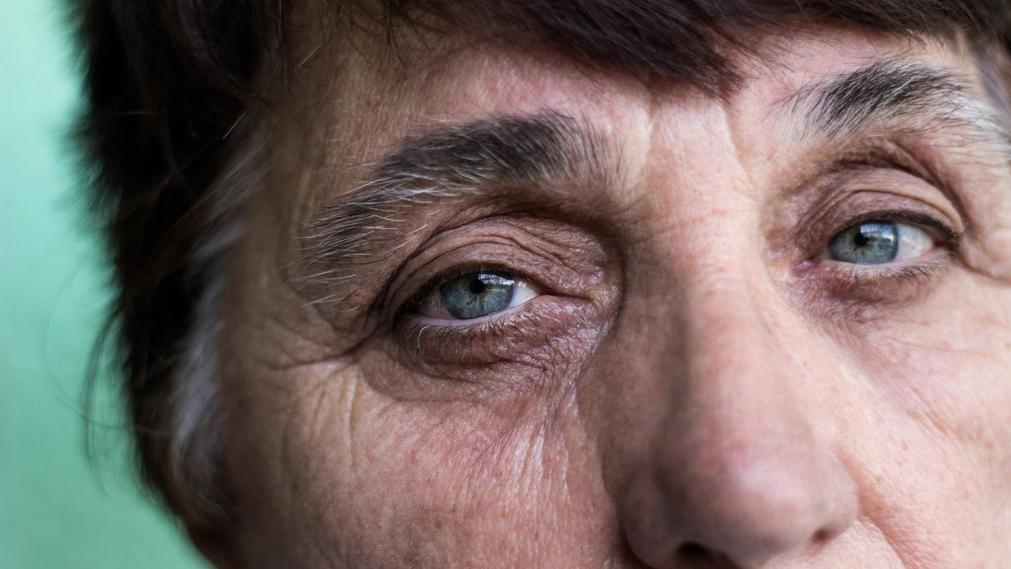 Vision in later life: older woman looking straight ahead, lost in thought.