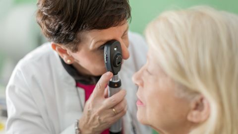 Glaucoma: doctor looking into a patient’s eye through a retinoscope.