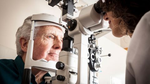 Age-related macular degeneration: man having his eyes examined by an optician.